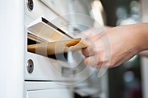 Woman putting envelope in mailbox