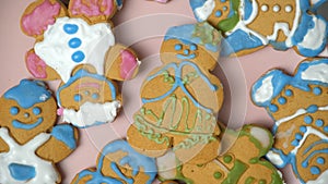 Woman putting gingerbread Christmas cookies in the shape of men on a plate, hand top view