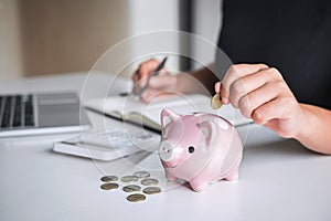 Woman putting golden coin in pink piggy bank for step up growing business to profit and saving with piggy bank, Saving money for