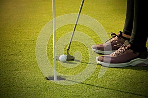 Woman Putting on the Green with Golden Light