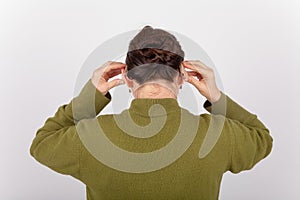 Woman putting on hearing aids