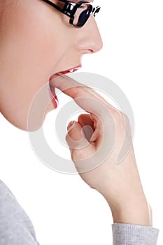 Woman putting her finger in her mouth