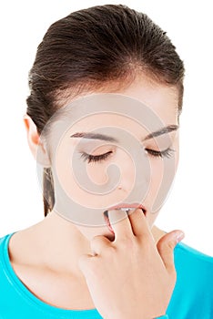 Woman putting her finger in her mouth to provoke vomiting