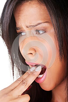 Woman putting her finger in her mouth to provoke vomiting.