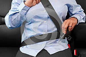 Woman putting on her seat belt