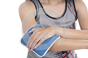 Woman putting an ice pack on her elbow pain