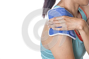 Woman putting an ice pack on her shoulder
