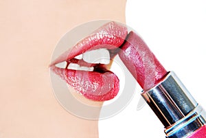 Woman putting on lipstick