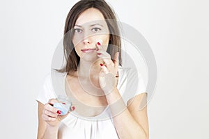 Woman putting lotion on