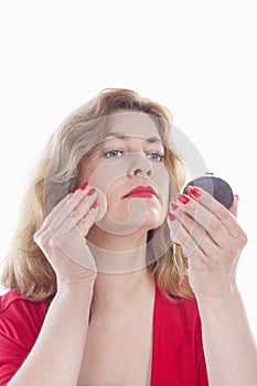 Woman putting on makeup