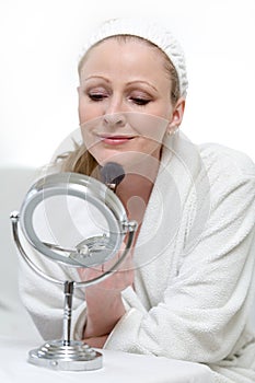 Woman putting on makeup