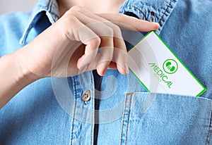 Woman putting medical business card into pocket. Nephrology service