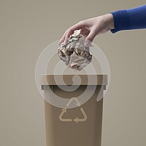 Woman putting paper in the trash bin