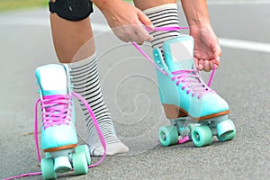 The woman is putting on roller skates
