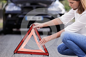 woman putting safety red triangle