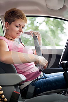 Woman putting seat belt