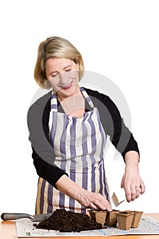 Woman putting seeds in soil