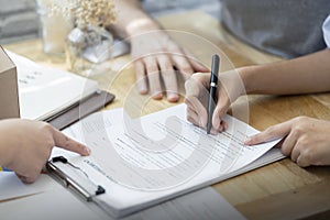 Woman putting signature on document loan contract, real estate purchase, hands of woman sale represent point document to sign,