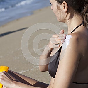 Woman putting some cream on