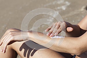 Woman putting some lotion on