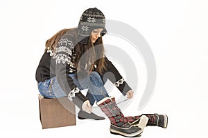 Woman putting on winter shoes.