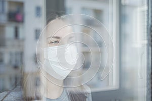 Woman in Quarantine Looking out the Window