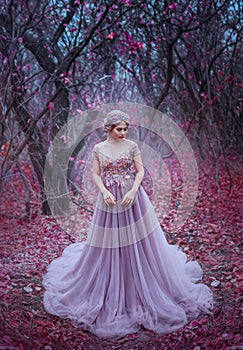 Woman queen in autumn magic forest trees. princess crown. Medieval long dress