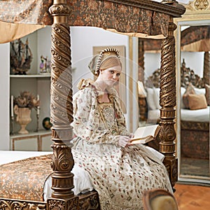 Woman, queen and book with portrait for renaissance, royalty aesthetic and reading in palace bedroom. Monarch, wealthy