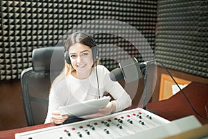 Woman radio broadcaster at recording studio