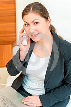 Woman with radiotelephone and laptop