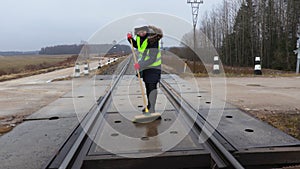 Woman railway employee clean with brush