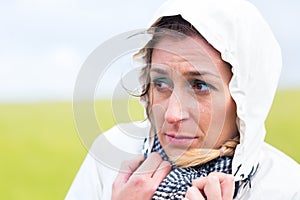 Woman in rain shower at sea coast