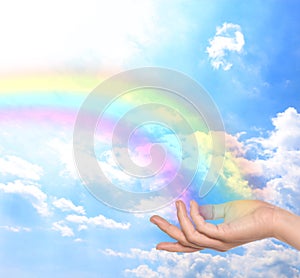 Woman and rainbow as source of healing energy on sunny day