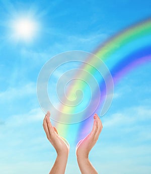 Woman and rainbow as source of healing energy on sunny day