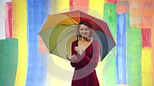 Woman with rainbow LGBT umbrella flag. Charming female cheerful attractive nice cute girlfriend with rain umbrella.