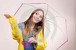 Woman in rainproof coat with umbrella. Forecasting