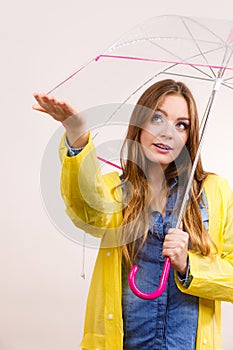 Woman in rainproof coat with umbrella. Forecasting