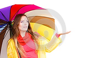 Woman in rainproof coat under umbrella