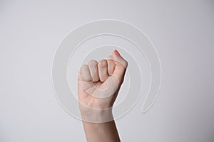 Woman raised fist, or the clenched fist,  isolated on white background