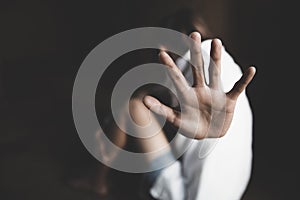 Woman raised her hand for dissuade, campaign stop violence against women with copy space, black and white color