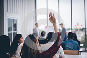 Woman raised up hands and arms  in seminar class room to agree with speaker at conference seminar meeting room.