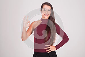 woman raises her fingers and smiles