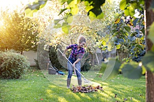 Woman raking leaves on lawn