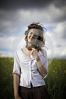Woman in rapeseed field with deep look