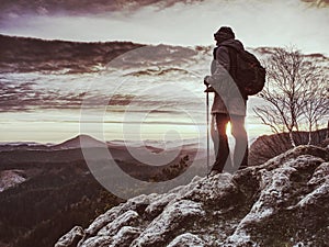 Woman reached mount peak. Girl wears backpack and sunglasses