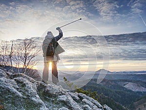 Woman reached mount peak. Girl wears backpack and sunglasses