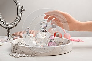 Woman reaching for crystal bottle of luxurious perfume