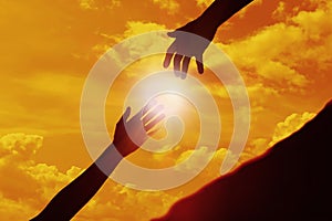 Woman reaching for man`s hand at sunset, closeup