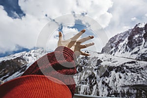Woman reaching out her hand up to the sky