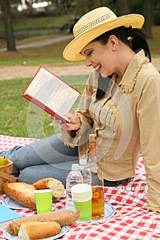 Woman Read Book And Enjoying Outdoor Picnic